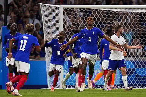 Loic Bade (4) celebrates scoring third goal for France